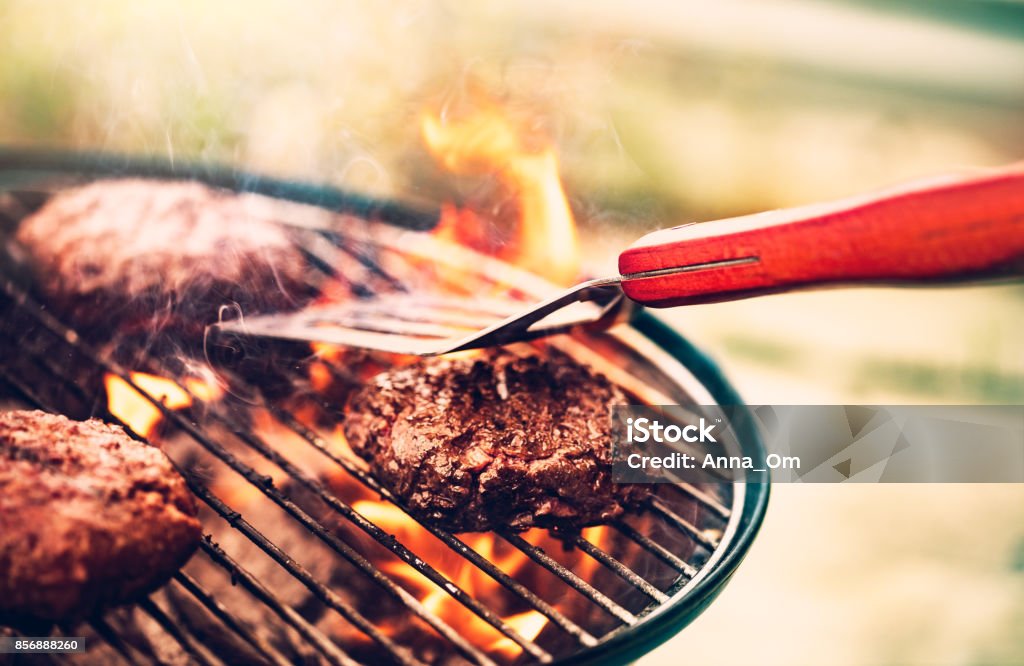 Tasty meat on the grill Tasty meat on the grill outdoors, preparing barbecue pork for burgers, traditional summer food cookout, good food for party outdoor Barbecue Grill Stock Photo