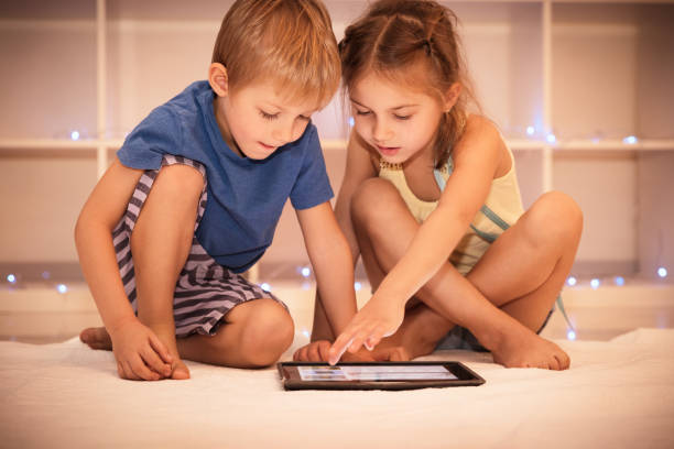 istock Two happy children playing on the tablet 856888332