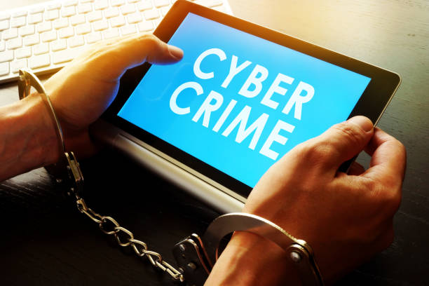 istock Man in handcuffs holding tablet with sign Cyber crime. 856899058