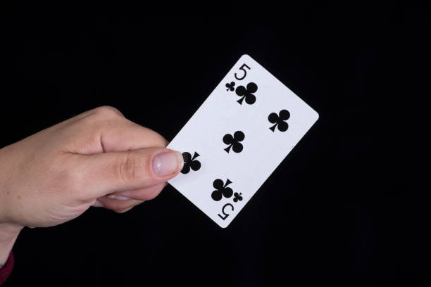 istock Hand holds a five of clubs card 856901788