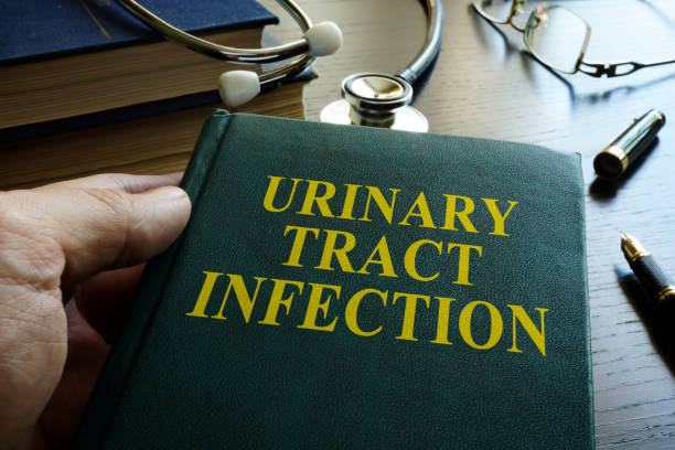 istock Man holding book about Urinary tract infection. 856905356