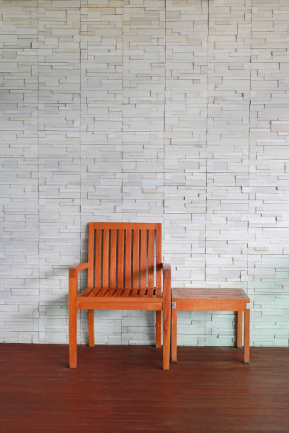 istock Indoor wood chair set against modern brick wall. 856908294