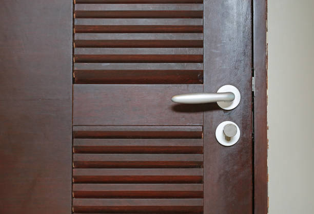 istock Door handle on wooden door. 856908826