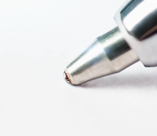 istock Macro of ballpoint pen tip on blank white paper 856909822