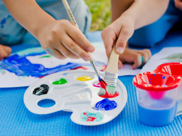 istock brushes and paint in children's hands 856913172