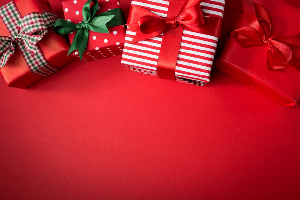 istock Wrapped gifts on red background 856913486
