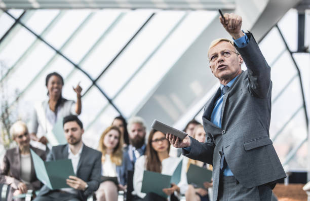 istock Business People on Conference Listening to Speaker 856916476