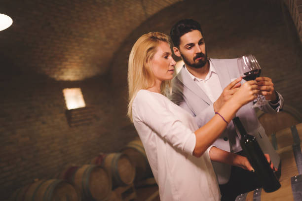istock People tasting red wine in winery basement 856917118