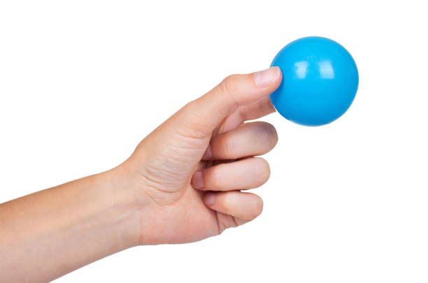 istock ping-pong ball in hand isolated on white background 856923918