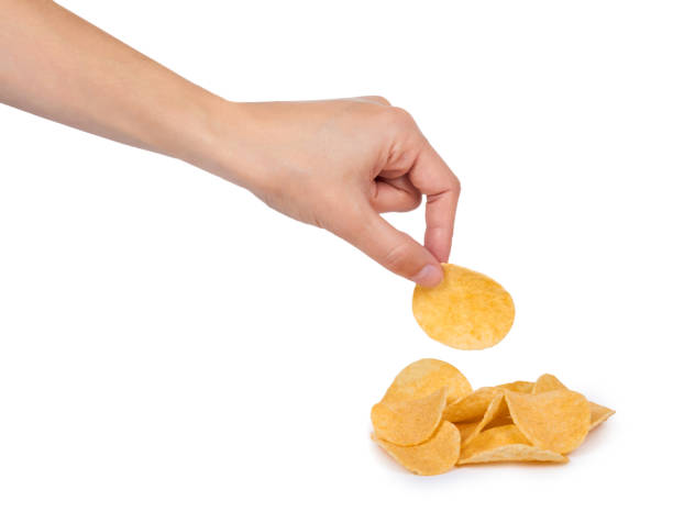 istock Potato chips in hand isolated on white background 856924066