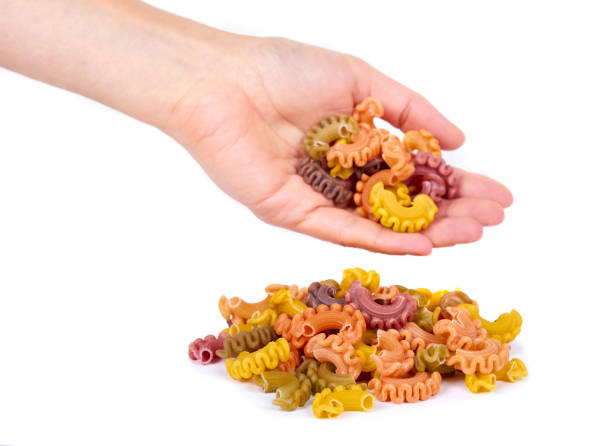 istock Pasta spiral in hand isolated on white background 856924072