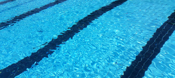 istock blue swimming pool background, with black lane 856932092