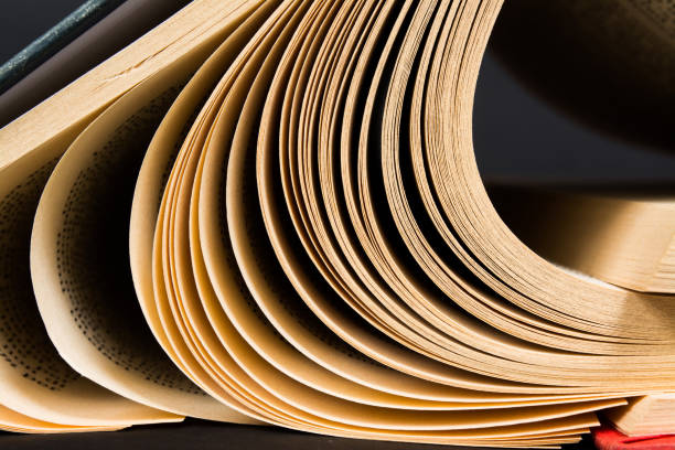 istock Vintage old open book on black background 856934868
