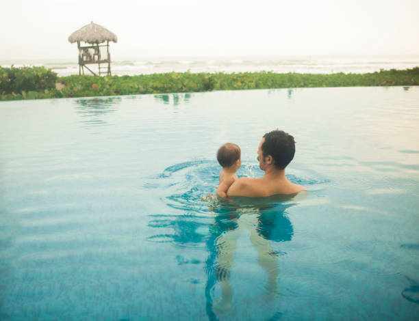 istock Father with son in the pool 856935020