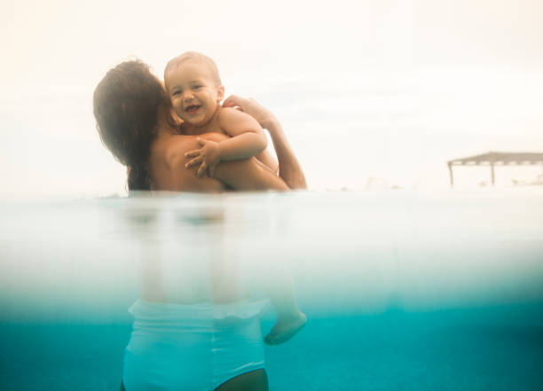 istock Mother with baby boy in swimming pool 856935174