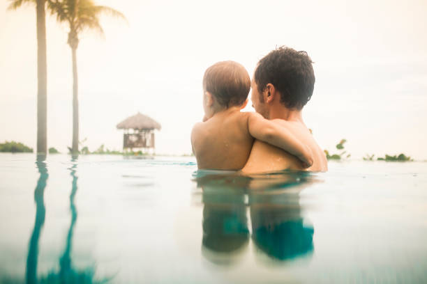 istock Father with son in the pool 856935412