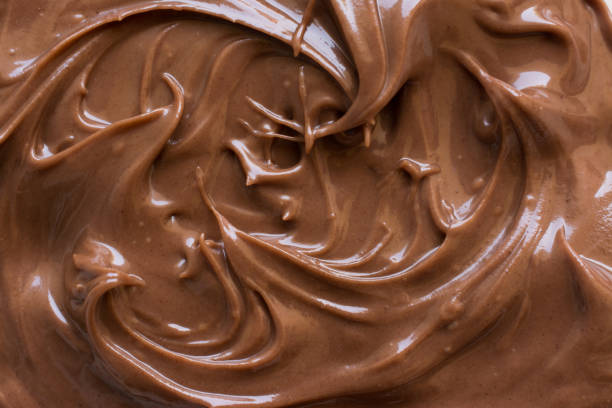 istock chocolate hazelnut spread on plate. Close up and background 856936558
