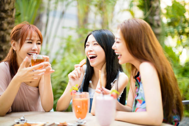 Group Of Female Friends talking In Restaurant garden Group Of Female Friends talking In Restaurant garden chinese ethnicity china restaurant eating stock pictures, royalty-free photos & images