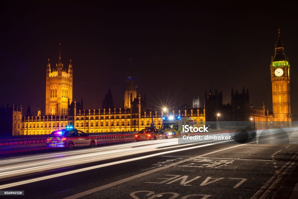Police Cars and Ambulance on Westminster Bridge, London at Night with The Houses of Parliament and Big Ben London - England Stock Photo