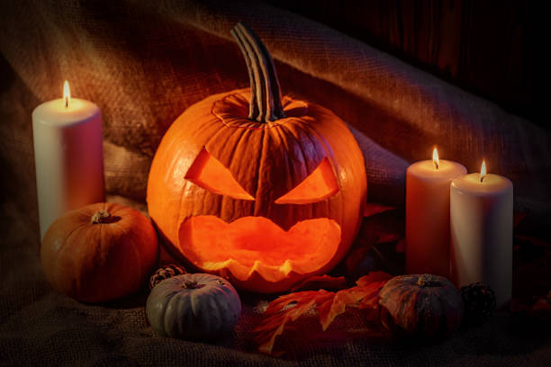 istock Halloween pumpkin head with burning candles 856942980