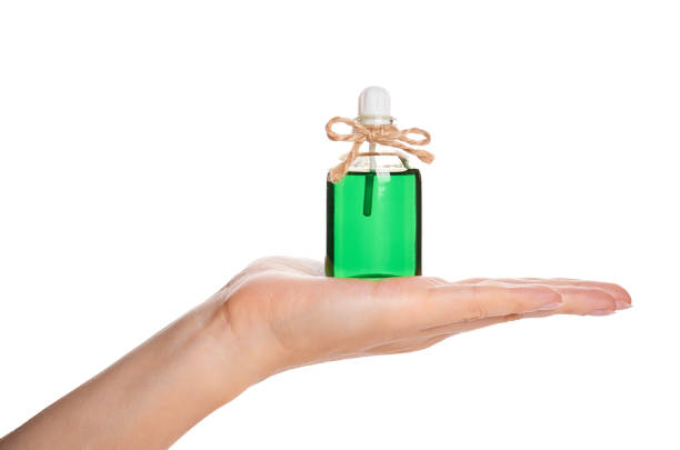 istock eco aroma oil bottle in hand isolated on white background 856947952
