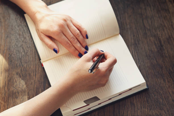 istock woman writes in the calendar 856949536