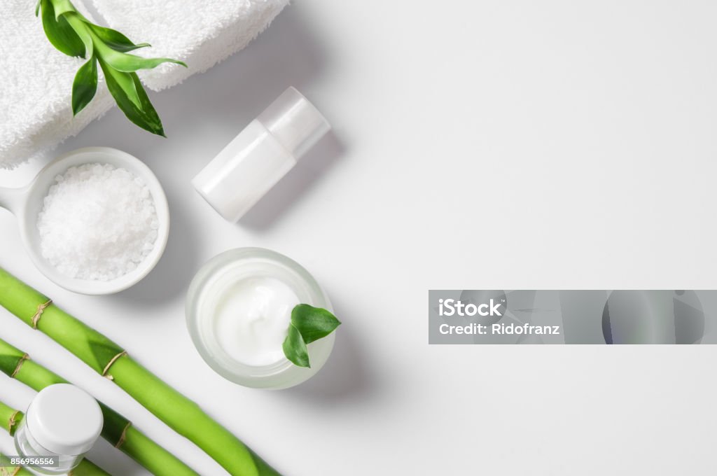 Moisturizer with bamboo sticks Top view of cosmetic products with natural ingredients on white background for natural beauty. High angle view of spa setting with natural moisturizer and bamboo sticks. Beauty spa background with copy space. Bamboo - Plant Stock Photo