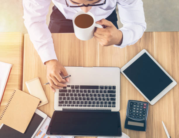 istock Businessmen are working on laptops and drinking coffee, top view. 856956646