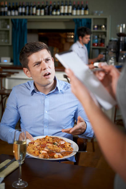 istock Customer In Restaurant Complaining To Waitress About Food 856968400