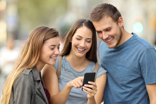 istock Happy group of friends using a smart phone 856968688