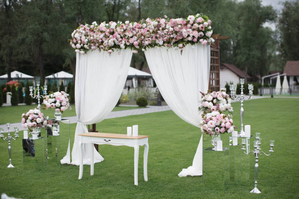 istock Outdoors wedding decoration with flower bouquets, candles and garlands 856968868