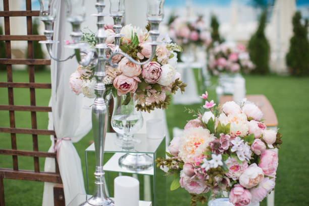 istock Outdoors wedding decoration with flower bouquets, candles and garlands 856968876
