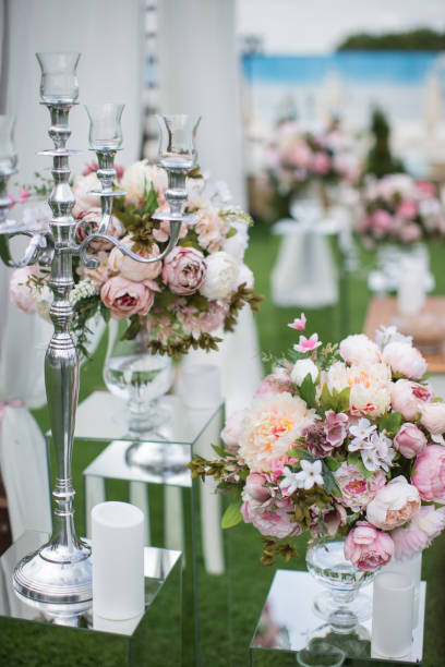 istock Outdoors wedding decoration with flower bouquets, candles and garlands 856968904