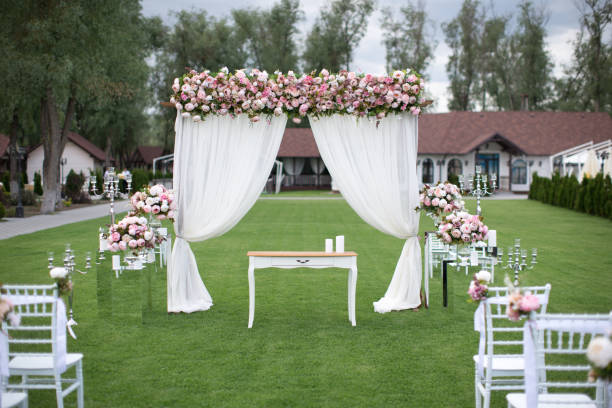 istock Outdoors wedding decoration with flower bouquets, candles and garlands 856969014