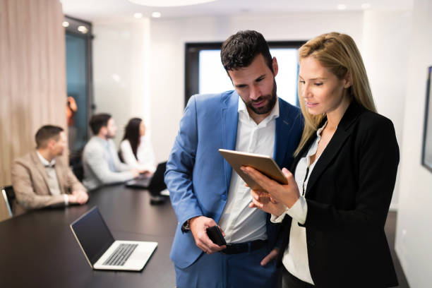 istock Attractive business couple using tablet in their company 856969098