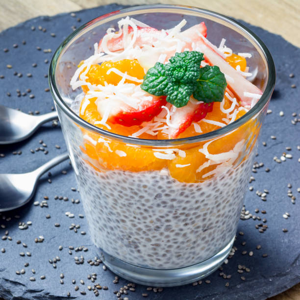 istock Chia seed pudding garnished with strawberries, mandarins and coconut slices, square format 856973044