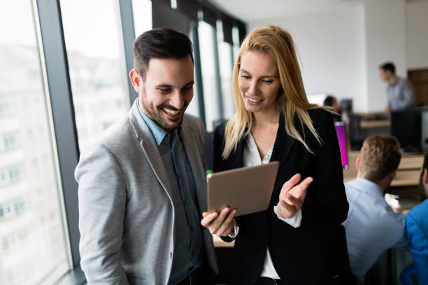 istock Attractive business couple using tablet in their company 856973564