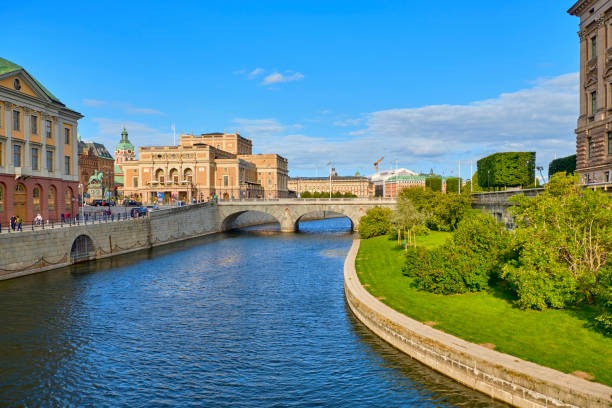 Cityscape of central Stockholm Cityscape of central Stockholm with Royal Swedish Opera building and Norrbro arch bridge over Norrstrom. Tourists and locals are walking around street. strommen stock pictures, royalty-free photos & images