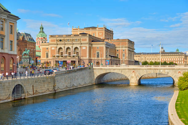 Cityscape of central Stockholm Cityscape of central Stockholm with Royal Swedish Opera building and Norrbro arch bridge over Norrstrom. Tourists and locals are walking around street. strommen stock pictures, royalty-free photos & images