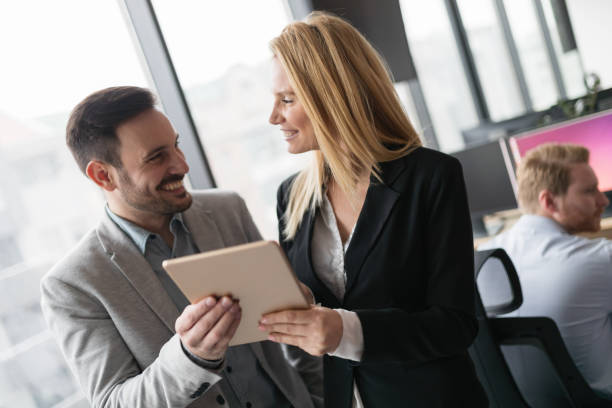istock Attractive business couple using tablet in their company 856973736