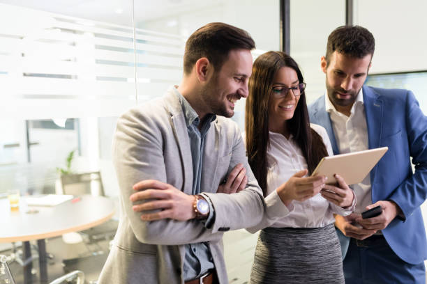 istock Businessmen and businesswoman using tablet in office 856974512