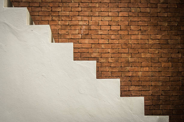 istock Side view of white empty stairs with brown brick wall background in vintage style. 856978718