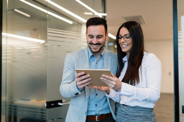 istock Attractive business couple using tablet in their company 856978818