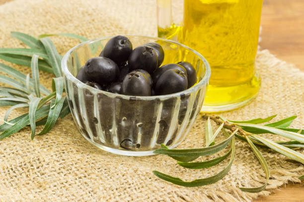 istock Black olives in small glass bowl closeup 856979252
