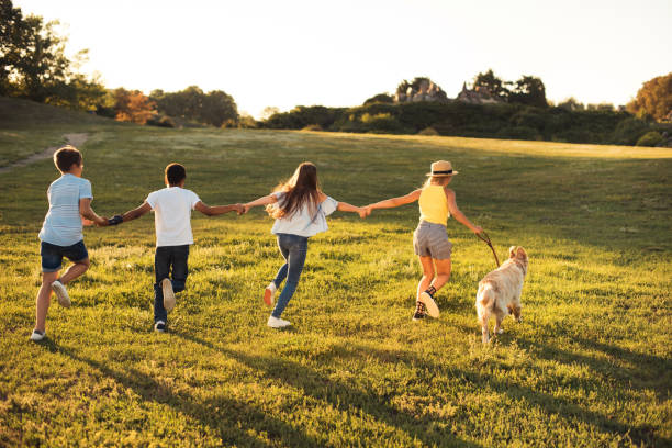 istock teenagers with dog in park 856980884