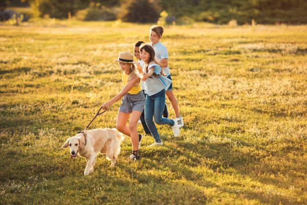 istock teenagers with dog in park 856981146