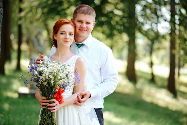 istock Bride and groom hold each other hands while they walk along the 856981562