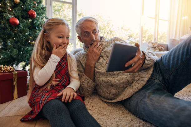 istock Surprised grandfather and granddaughter looking at digital tablet 856981698