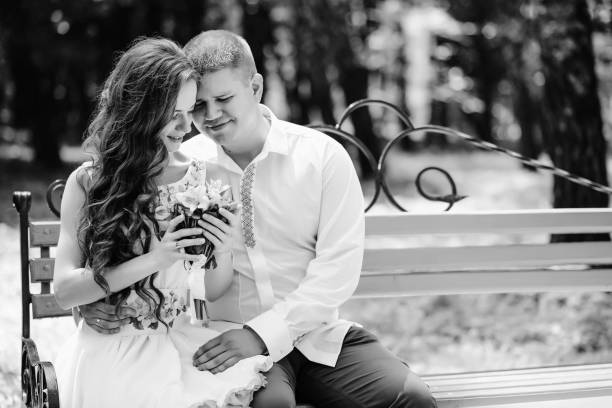 istock The bride and groom sit on a bench black and white 856981732