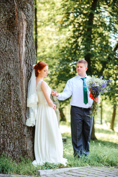 istock Bride and groom hold each other hands while they walk along the 856984156